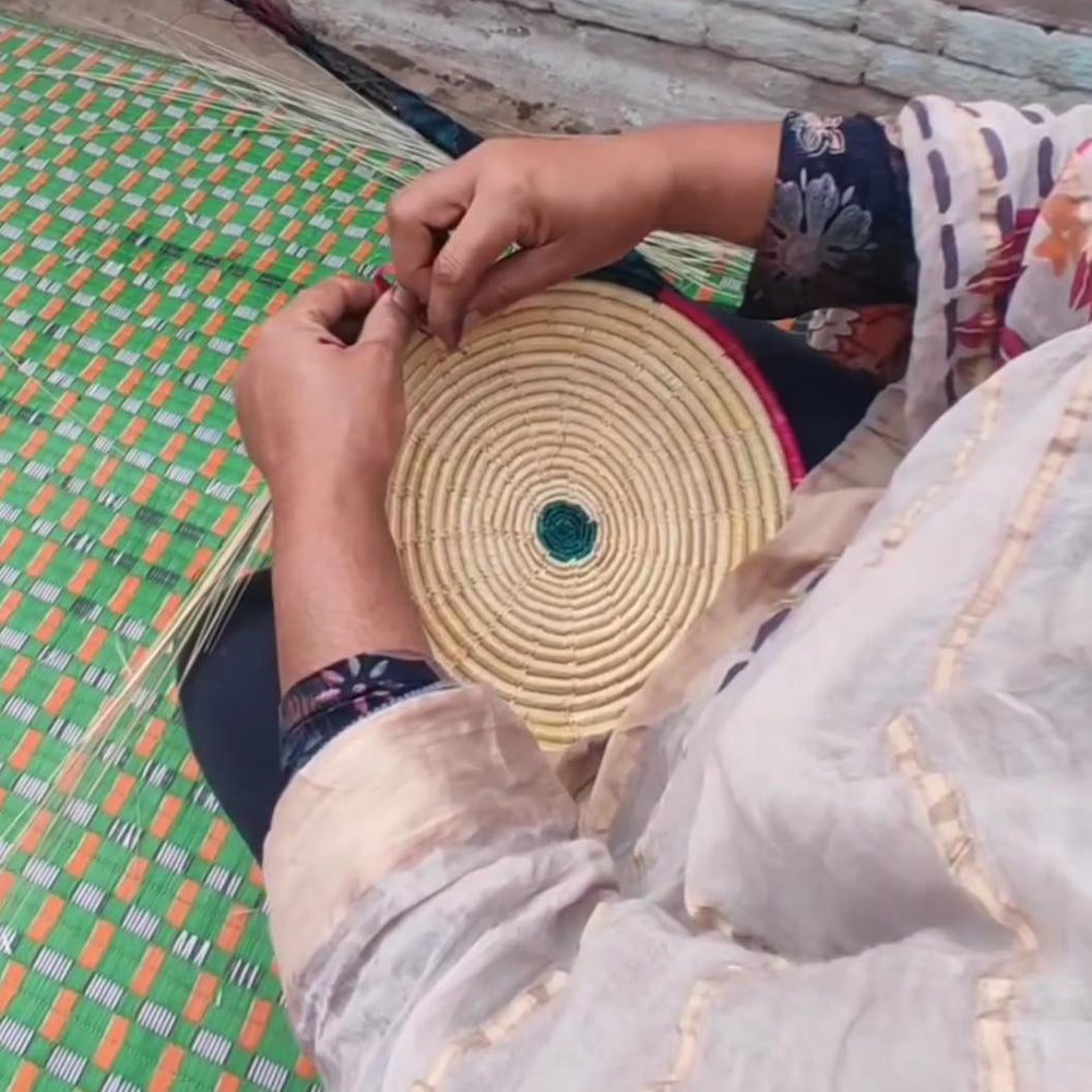 artisan weaving the basket