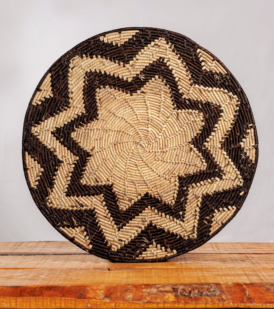 Eight Pyramid Black Hand-Woven Mat, 14-inch Diameter and 0.2-inch Depth.